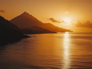 Fototapete Rund Golden sunset over calm sea with silhouetted mountains providing a dramatic view © Rapit