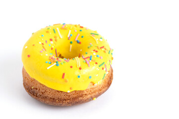 Yellow donut with sprinkles isolated on white background.