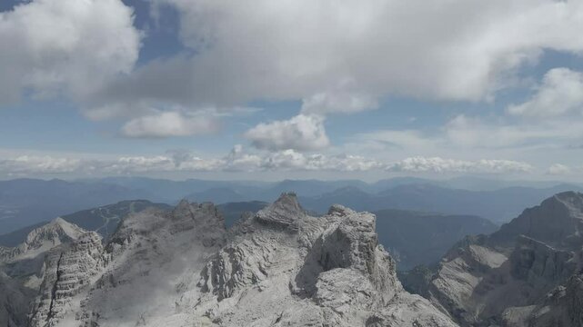 Drone footage of the Sentiero Alfredo Benini via ferrata in the Brenta Dolomites, showcasing the Canalino dei Camosci and the Cima Grost&eacute; with rugged limestone peaks, dramatic cliffs, and alpine lands