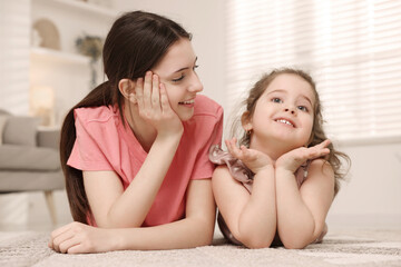 Portrait of cute little girl and her sister indoors