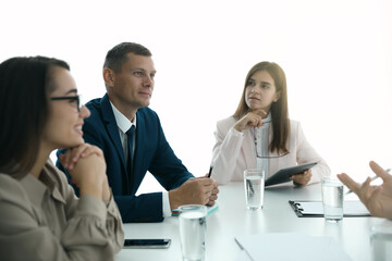 Fototapeta premium Office employees talking at table during meeting