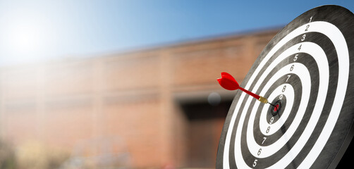 red dart on target board with blur background