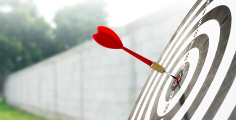 dart hitting target with wall background