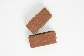 Cake bar covered with chocolate isolated on white background