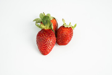 Fresh, ripe strawberry. Whole strawberry with leaf isolated on white background. Perfect retouched strawberry, not AI.