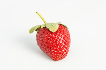 Fresh, ripe strawberry. Whole strawberry with leaf isolated on white background. Perfect retouched strawberry, not AI.
