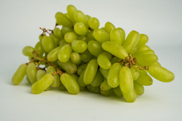 Fresh green grape cluster isolated on white background.