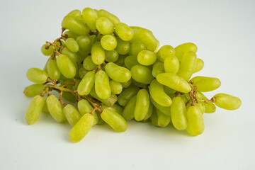 Fresh green grape cluster isolated on white background.