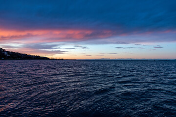 Muggia (Trieste, Italy): colourful sunset over the Adriatic Sea rippled by the waves 