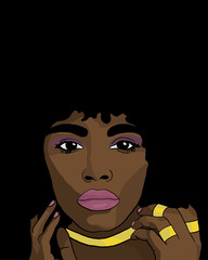 Face of a woman with black hair and gold accessories
