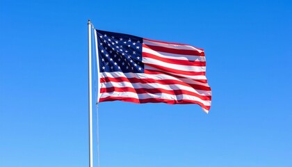 Naklejka premium American flag waving against a clear blue sky