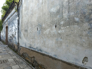 Weathered Wall in Narrow Alleyway Evoking Urban Charm
