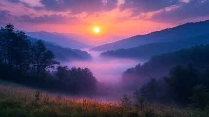 Obraz premium A breathtaking view of a pink sunrise over misty mountains, showcasing nature's stunning beauty