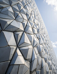 Architectural Facades: Metallic Honeycomb Facade Reflecting Sunlight on a Contemporary Architectural Design