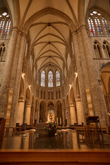 Obraz premium Interior of collegiate church of saint gertrude showing vaulted ceiling and stained glass windows. Belgium tourism
