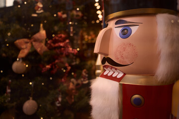 Traditional wooden nutcracker guarding christmas tree lights. Belgium tourism