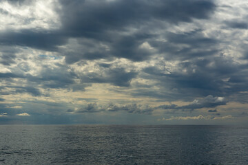 A huge cloudy sky filled with thick cumulus clouds creating a dramatic spectacle. Midsummer, Black Sea beach