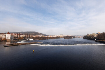 Fototapeta premium Vltava river flowing showing prague castle on sunny day