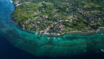 Aerial view of vibrant coastal community on Cebu Island during sunny daylight
