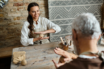 Couple enjoys quality time while shaping clay in a pottery class, sharing laughter and creativity.