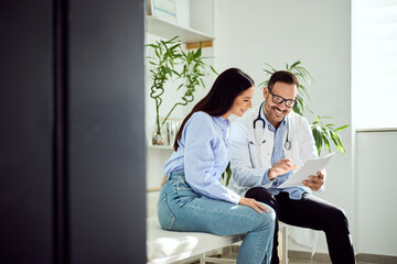 Doctor Consulting Patient in Bright Office with Plants and Modern Interior Decor