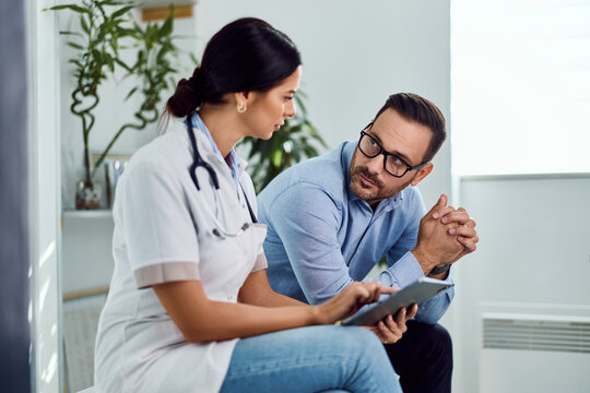 Doctor Consulting Patient in Modern Office During Informative Medical Meeting - Powered by Adobe