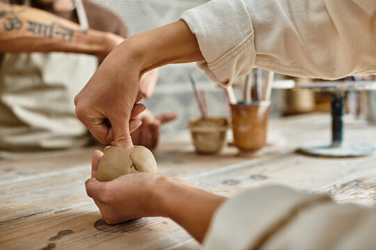 Couple joyfully shaping clay together in a pottery class, strengthening their bond.