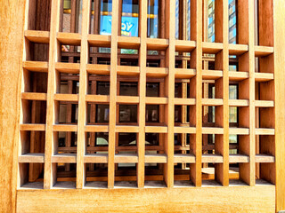 Intricate wooden lattice design with space for text and background texture in natural light