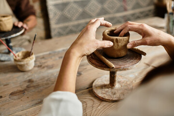 woman cherishes quality time as she shape clay during a pottery class.