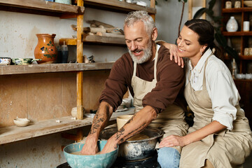Mature couple enjoys shaping clay in a pottery class, sharing love and creativity.