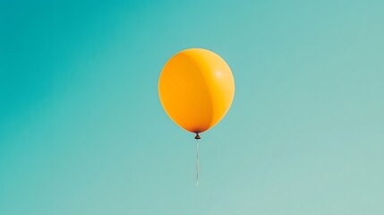 Obraz premium Bright Yellow Balloon Floating in a Clear Blue Sky,Representing Freedom and Joy