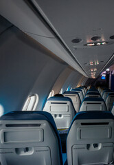Inside a nearly empty aircraft cabin on a tranquil flight in early morning light