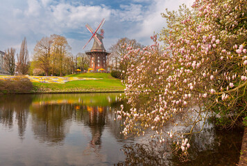 The Mill on the Wall in Bremen, Germany, surrounded by vibrant spring flower beds