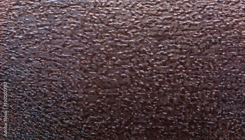 Poster close-up of textured dark brown metallic surface with fine ripples and glossy reflections, ideal for