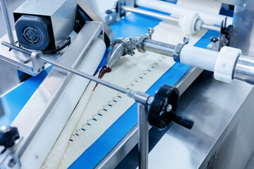 Automated production of puff pastry buns with dough formation and filling injection process, top view