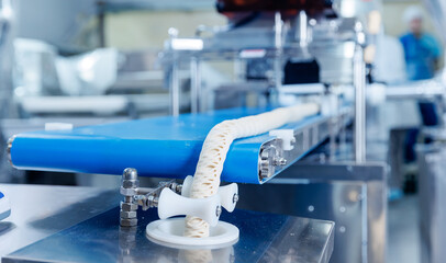 Automated puff pastry production line, dough extrusion and conveyor processing