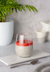 Food photography of breakfast of chia seeds pudding with strawberry puree, berry jam,  healthy vegan dessert, natural food