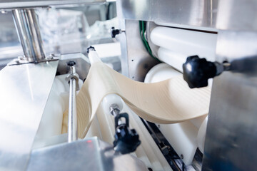 Automated dough formation in puff pastry production at confectionery facility, food industry factory