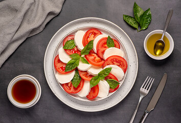 Food photography of salad caprese with mozzarella cheese, tomatoes, basil, olive oil, Italian cuisine, healthy natural dish
