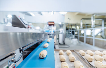 Automated puff pastry bun production on conveyor line in confectionery facility, food industry...