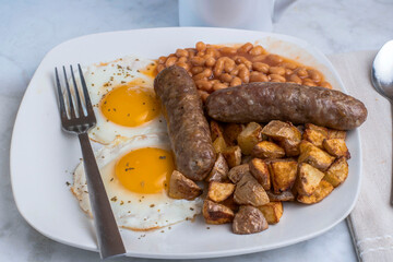 two ried eggs top with parsley  with  sweet italian sauage