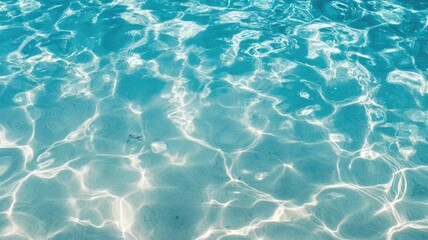 Obraz premium Clear turquoise ocean water with sunlit ripples and reflections