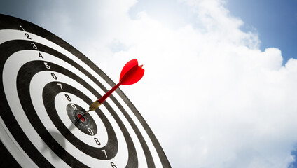 red dart on target copy space with cloud background