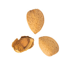 Two whole Iranian almonds with shells and one cracked almond on a white background.