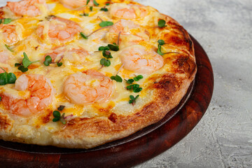 four cheese pizza with shrimp and fresh microgreens, served on a wooden board, homemade, no people,