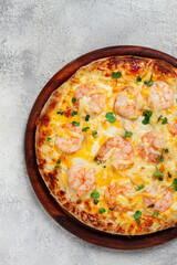 four cheese pizza with shrimp and fresh microgreens, served on a wooden board, homemade, no people,