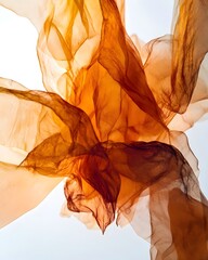 Fototapeta premium Abstract composition of flowing orange fabric creating a sense of movement and texture.