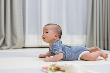 Fototapeta premium Happy newborn baby on comfortable play mat