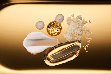 Textures of different cosmetic products on a gold background.