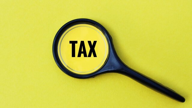 tax concept, Magnifying glass over the word tax.
